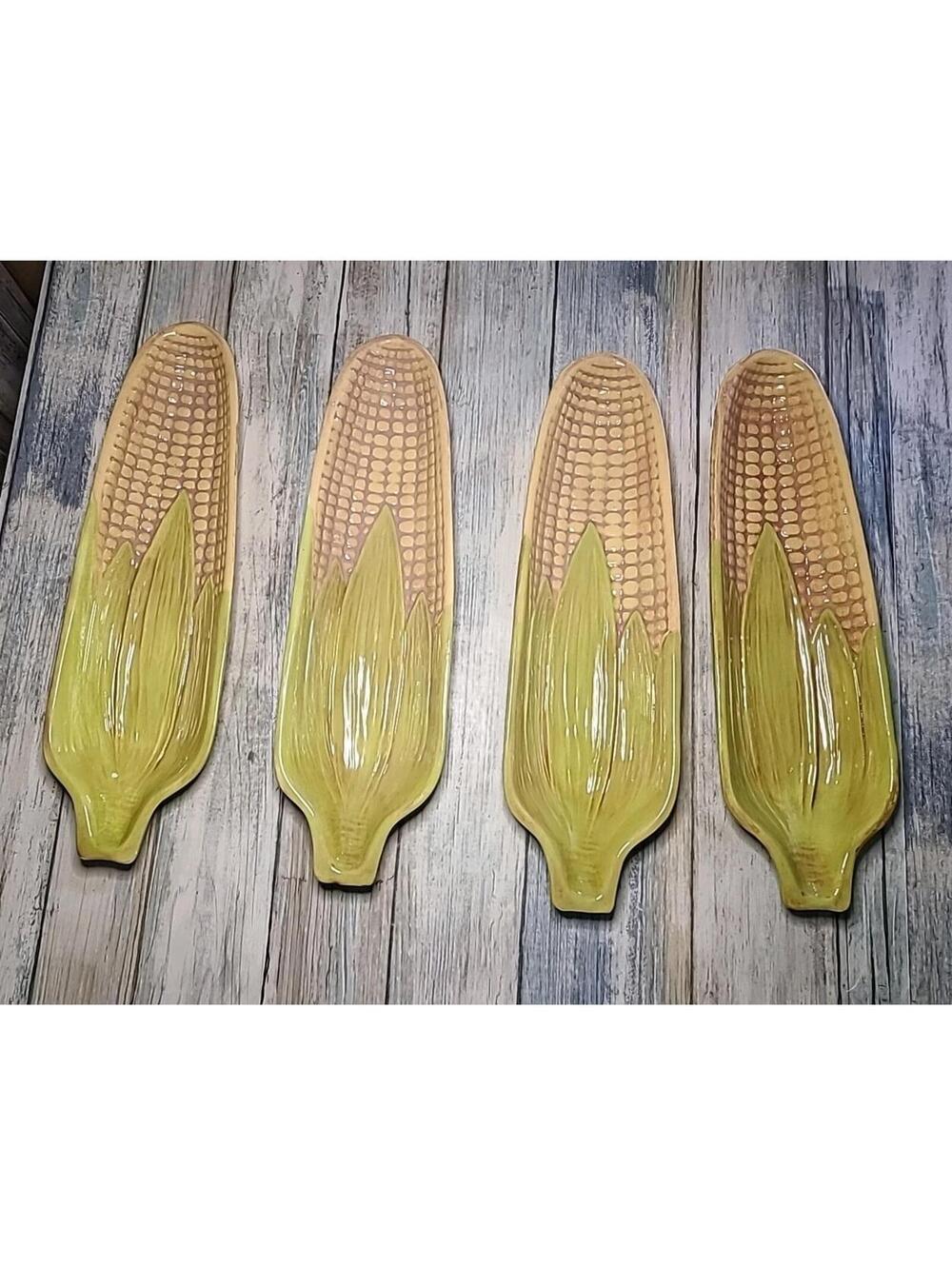 4 ceramic corn-on-the-cob serving dishes feature a molded kernel and husk design